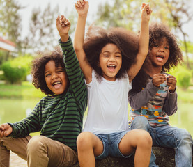 Happy kids group playing in the park in school.