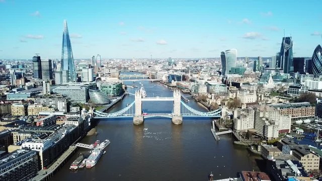 Aerial drone bird's eye view video of iconic Tower Bridge and skyline in City of London, United Kingdom