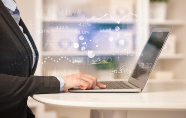 Business woman in homey environment using laptop with financial report concept
