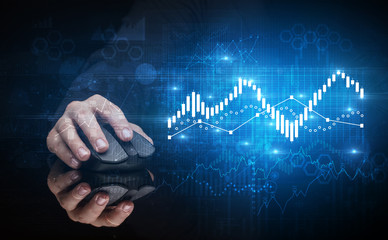 Hand using wireless mouse with statistical concept on dark background
