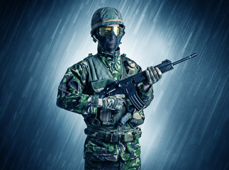 Armed soldier standing in rainy weather
