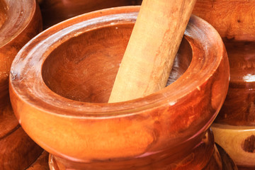 Wooden mortar and pestle for sale at the market. Mortar and pestle is a kitchen implement used to prepare ingredients or substances by crushing and grinding them into a fine paste or powder.