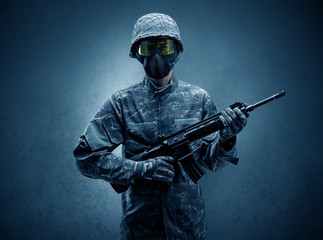 Soldier agent in a dark room with arms on his hand and gas mask
