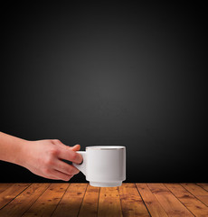 Cup of drink on wooden table with dark background
