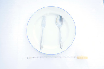 Dietary recipe dishes for eat. yellow measuring tape measure the dish with spoon and fork....