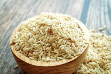 Close up of dirty rice on wooden bowl.