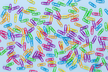 Paper color clip notebook on blue background. Flat lay.