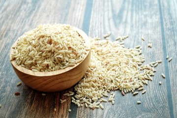 Close up of dirty rice on wooden bowl.