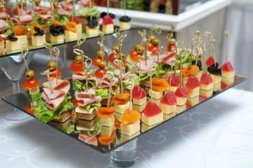 Delicious canapes with ham, cheese and fruit.
