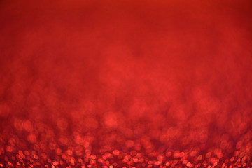Red glitter background.Defocused
