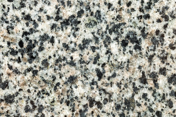 Marble texture with different colored spots. The surface of granite stone with streaks, spots and patterns of different colors. Visible stone texture with thick lines and mottled spots. 