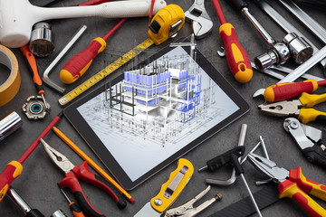 Fototapeta premium Tablet with construction tools and 3d house plan concept 