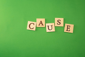 The word cause written on wooden cubes green background