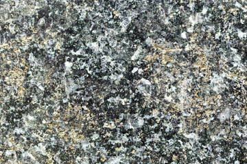 Marble texture with different colored spots. The surface of granite stone with streaks, spots and patterns of different colors. Visible stone texture with thick lines and mottled spots. 
