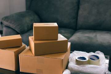 Parcel boxes and equipment for packaging placed on the table.