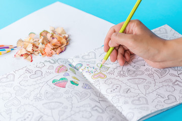 Anti stress adult coloring book. Woman coloring adult coloring books. Art color therapy. New stress relieving trend. Anti stress exercise at home