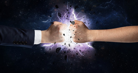 Naklejka na ściany i meble Two hands fighting with storm explosion concept 