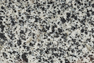 Marble texture with different colored spots. The surface of granite stone with streaks, spots and patterns of different colors. Visible stone texture with thick lines and mottled spots. 