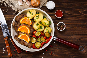 Fototapeta na wymiar Grilled steak, boiled potatoes and vegetables