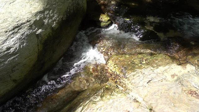 Slow motion video of small waterfall and river flowing located in Greek island