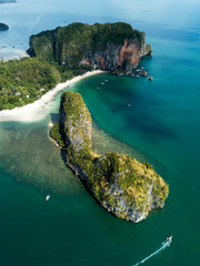 Aerial view of green rocky cliffs and boats on Phra Nang beach bay, Railay beach, in Krabi...