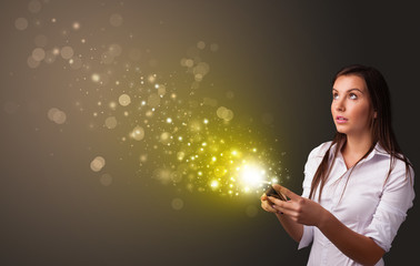 Person using phone with gold sparkling concept
