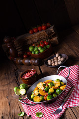 Brussels sprouts potato pan with bacon in rustic style