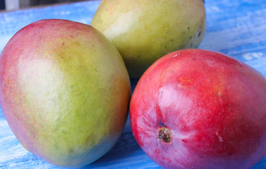 ripe, juicy mango on a wooden background