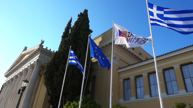 Slow motion video from iconic public Zappeion hall with Greek flag waving, Athens historic center, Attica, Greece
