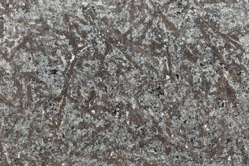 Marble texture with different colored spots. The surface of granite stone with streaks, spots and patterns of different colors. Visible stone texture with thick lines and mottled spots. 
