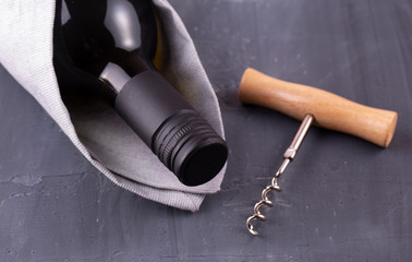The Glass bottle of white wine with corks on wooden table background