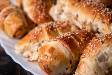 Fresh and hot homemade roll pastry with cheese and sesame