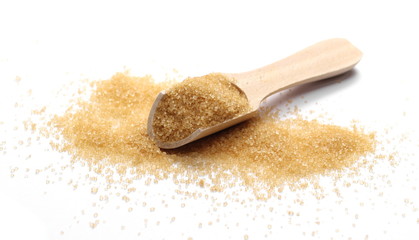 Brown cane sugar pile with wooden spoon isolated on white background and texture