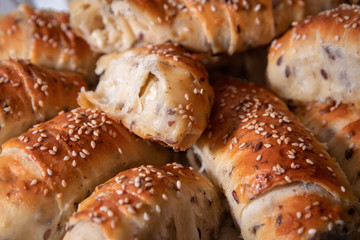 Fresh and hot homemade roll pastry with cheese and sesame