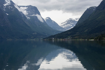 Hjelle valley surrounded by high glacier capped mountains in a landsape in Sogn og Fjordane, Norway.