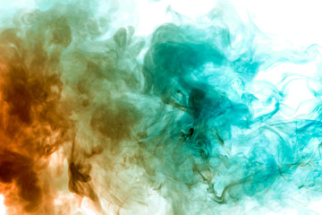 Fototapeta na wymiar Colorful steam exhaled from the vape with a smooth transition of color molecules from yellow to blue on a white background like a collision of two jets of smoke.