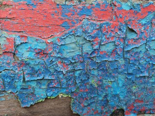 Blue and red cracked plank paint on old boards stock photo