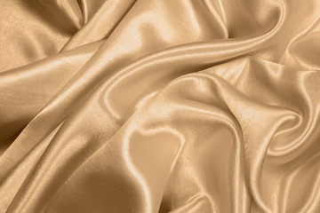 Beautiful smooth elegant golden silk or satin texture can use as abstract background. fabric color