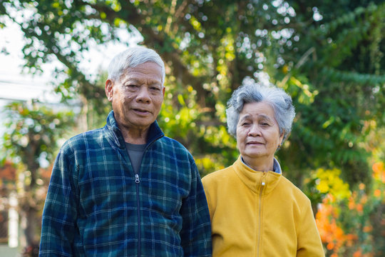 Portrait of romantic elderly man with his wife at home garden.