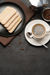 Italian Savoiardi ladyfingers Biscuits and cup of coffee on concrete backgound