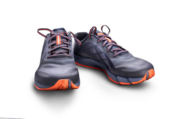 Front view of gray and orange trainers isolated on a white background.