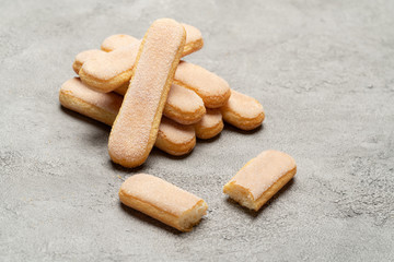 Italian Savoiardi ladyfingers Biscuits on concrete backgound