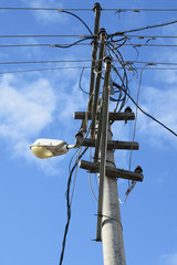 Electric pole under blue sky