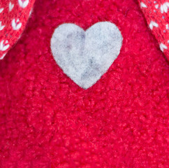 A heart sewn in a red woolen sweater