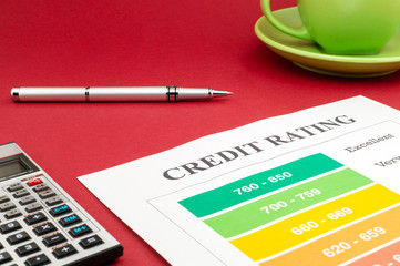 Credit report on the red table and a pen.