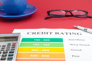 Credit report on the red table and a pen.