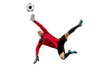 Fototapeta premium Male soccer player goalkeeper catching ball in jump. Silhouette of fit man with ball isolated on white studio background
