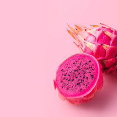 Fresh organic red dragon fruits on a pink background with copy space