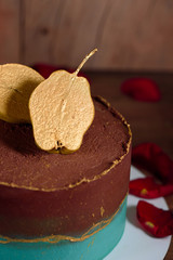 Chic cake with chocolate and pear cream. Delicious cake for the holiday decorated with pear.