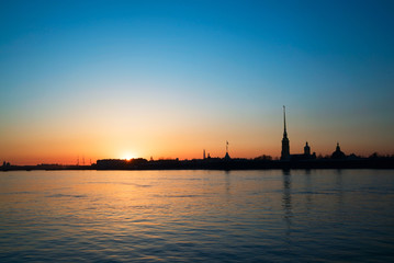 Fototapeta premium Sunset over the Neva river on the background of Peter and Paul fortress. White night. Saint-Petersburg.